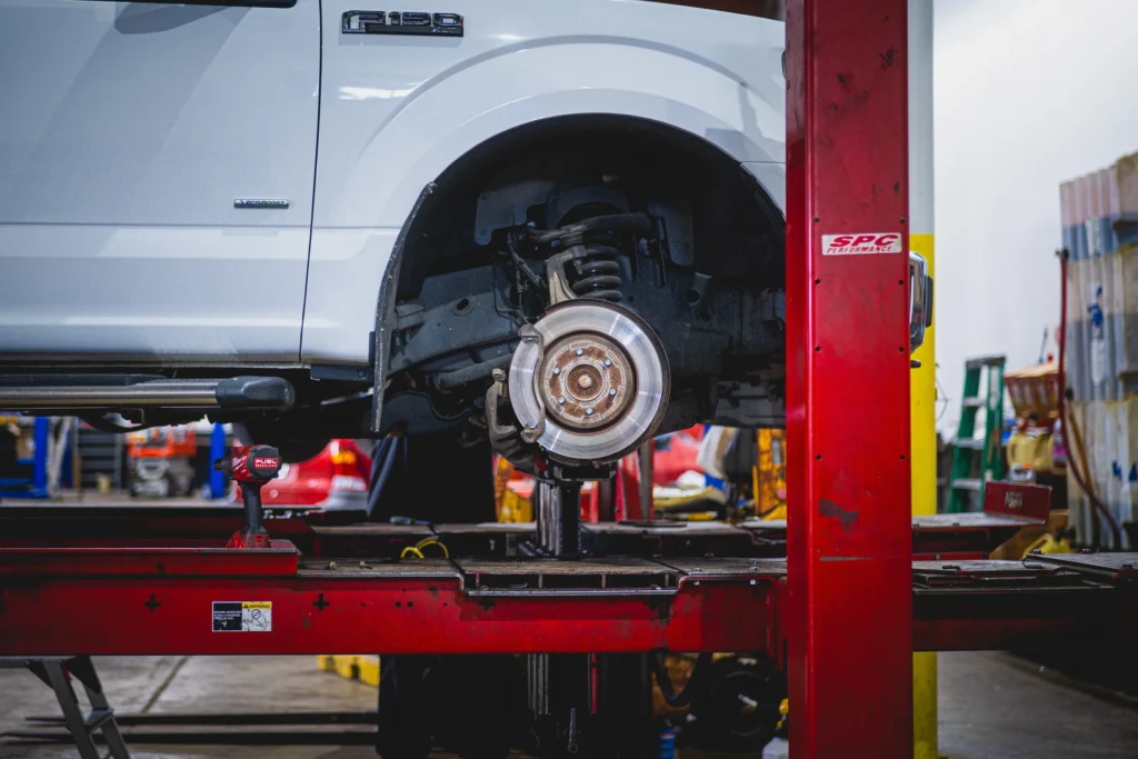 Car on lift with wheel removed