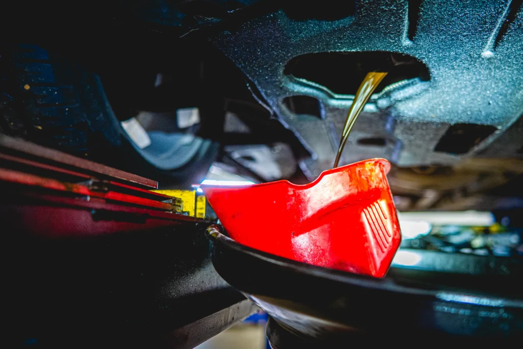 Oil draining into red container