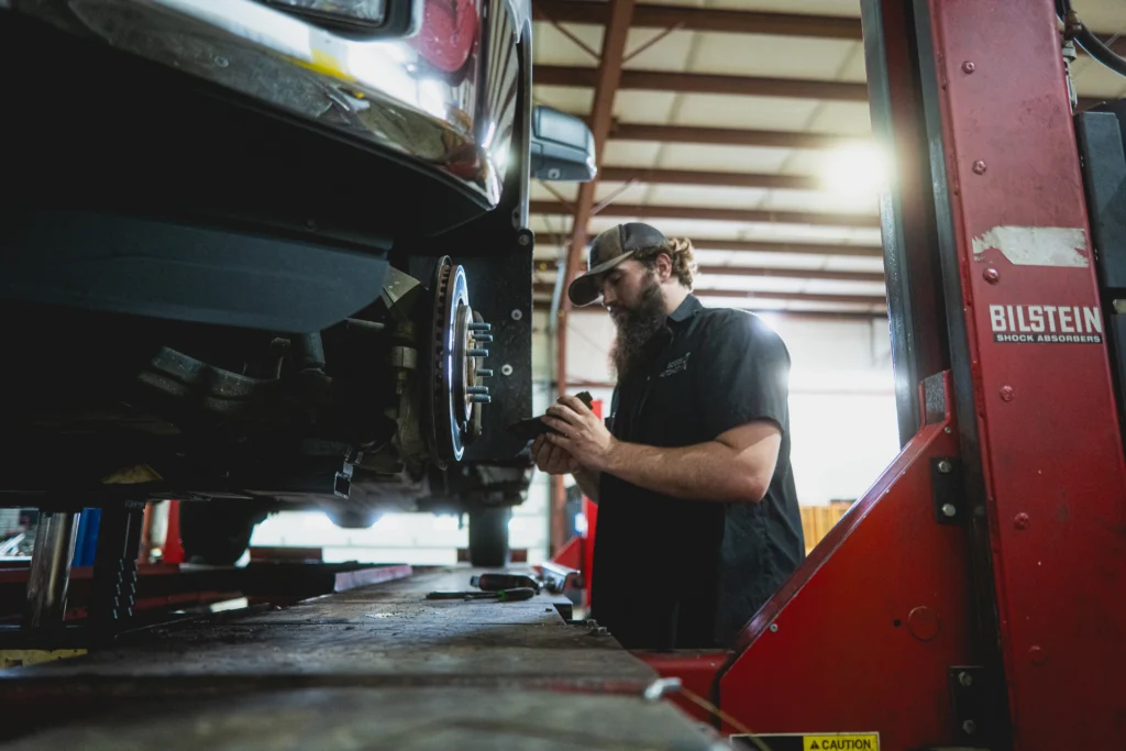 Mechanic working on a car's brakes.