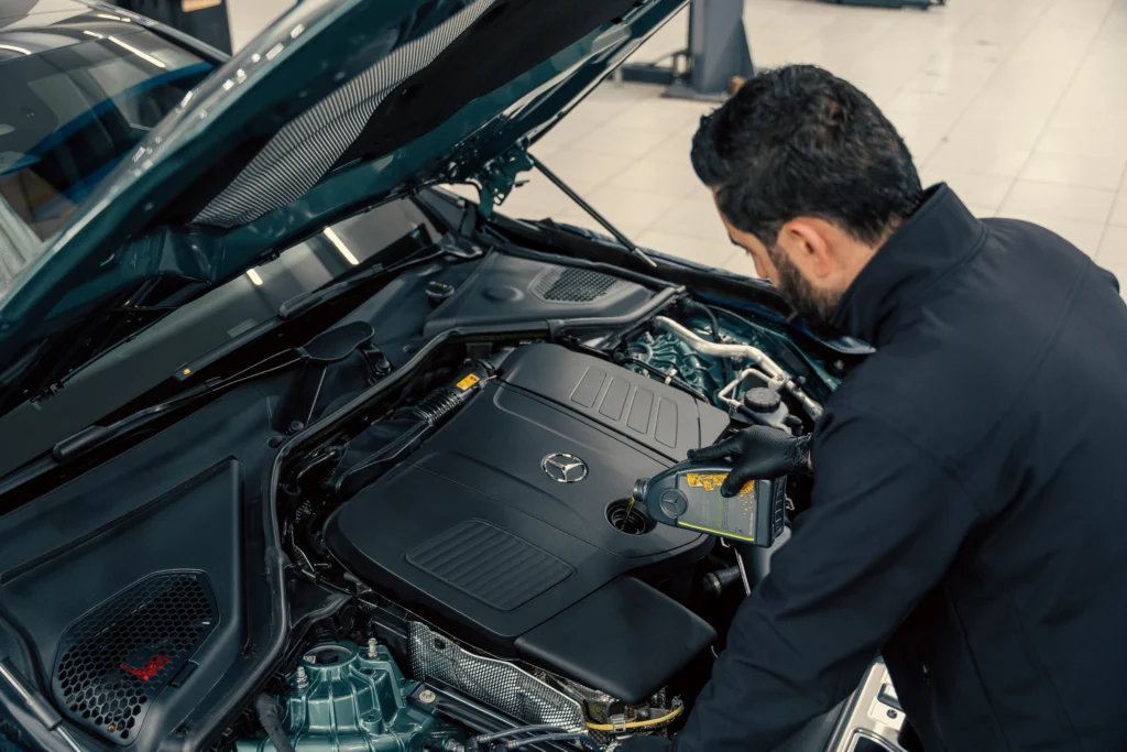 Man checking car engine oil level