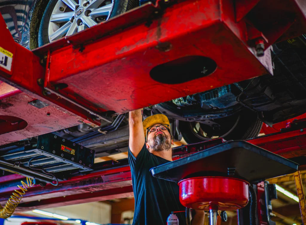 Mechanic working under elevated vehicle