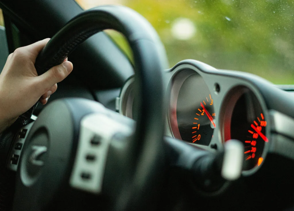 Driver's hand on steering wheel